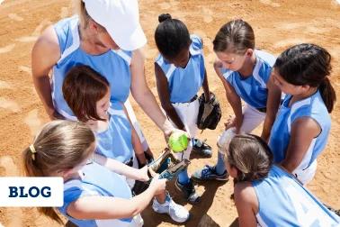 Female youth Softball team huddle