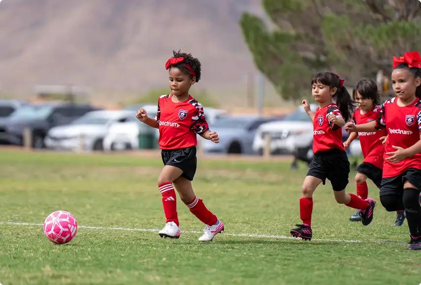Youth girl athletes playing soccer