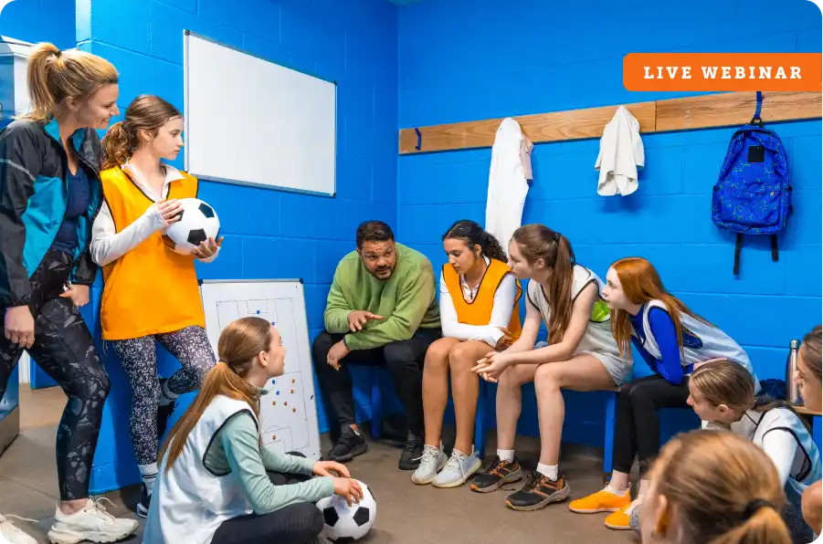 Coach talking to her youth female soccer team