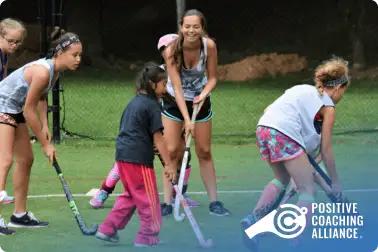 Female coach teaching hockey