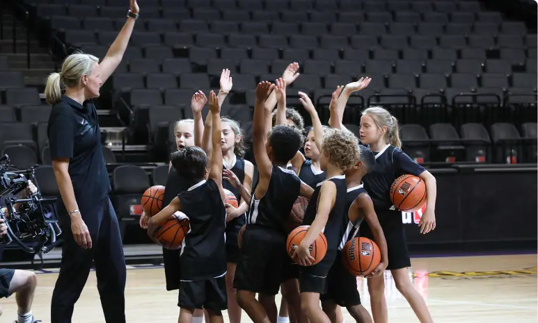 Female Basketball Coach with her youth team