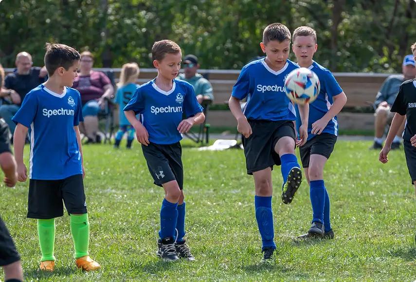 Youth male athletes playing soccer