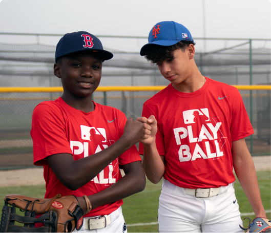 Two male baseball players fist bumping each other