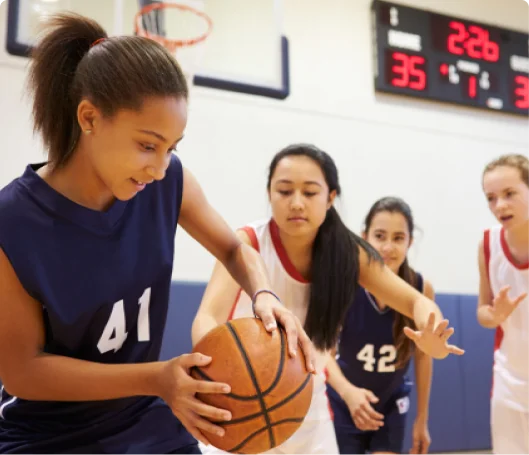 Girls playing basketball game