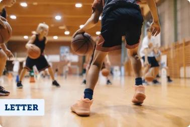 Youth athletes playing basketball