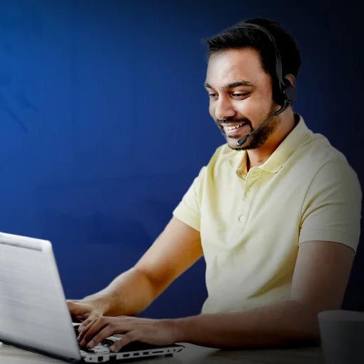 Man with headphone working on a laptop