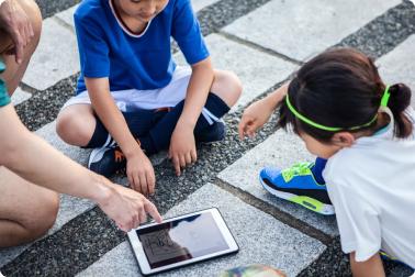 Youth athletes playing on a tablet