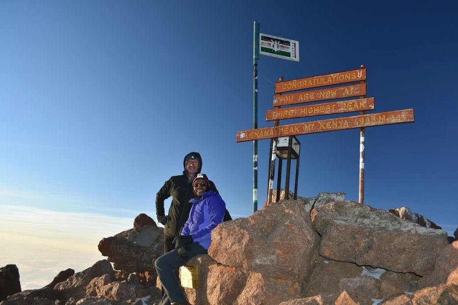 Trekkers celebrating at Point Lenana summit, Mount Kenya at 4,985m