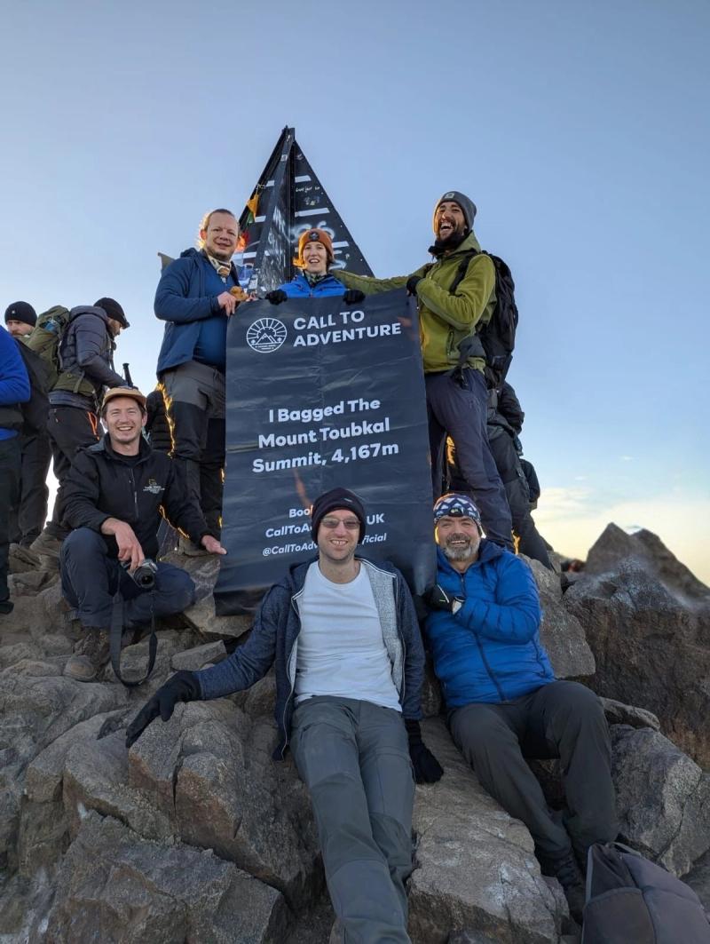 trekkers celebrate at the top of toubkal