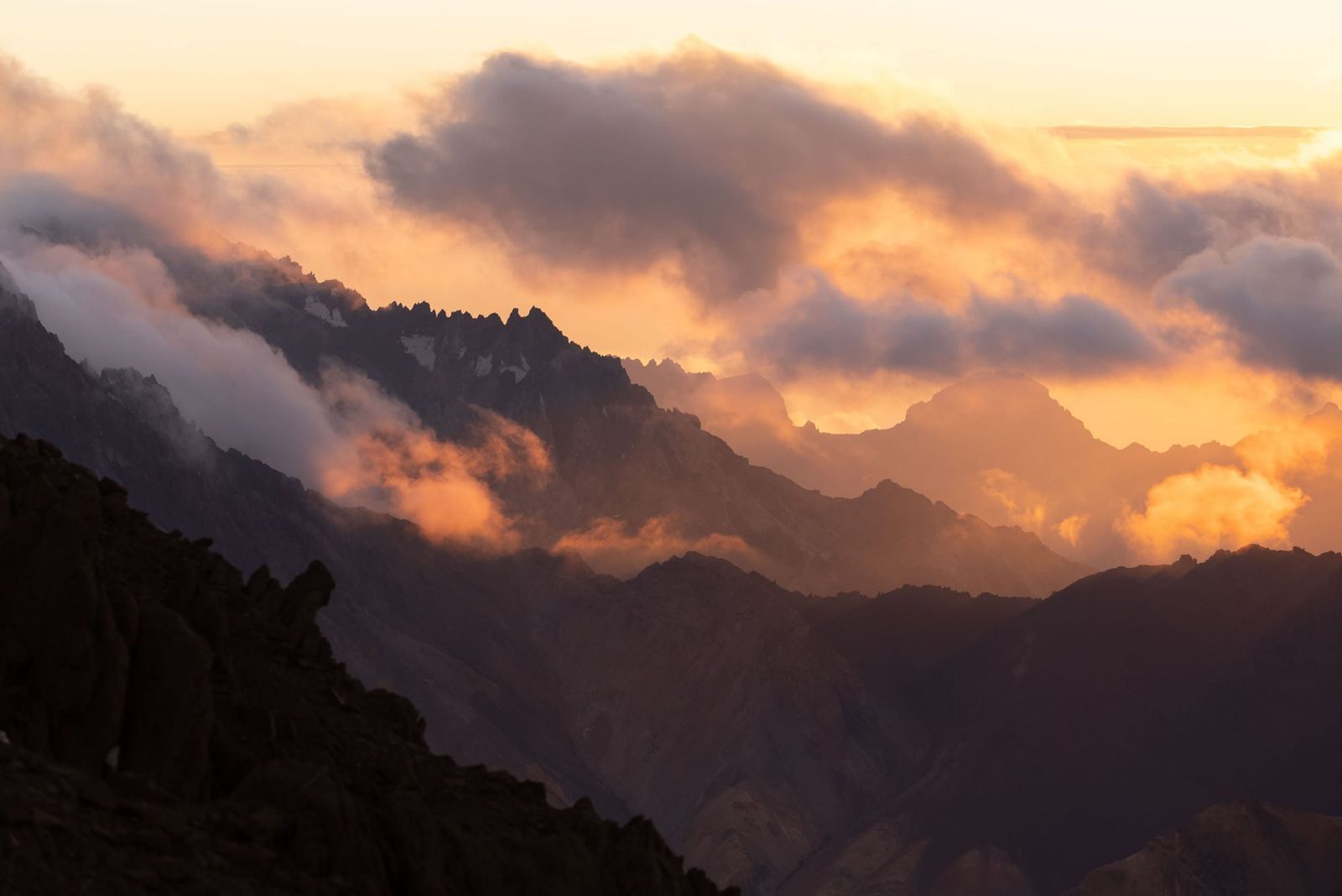 Golden hour sunset over Aconcagua with dramatic cloud formations