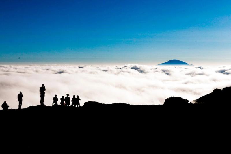 People looking over view at Kilimanjaro
