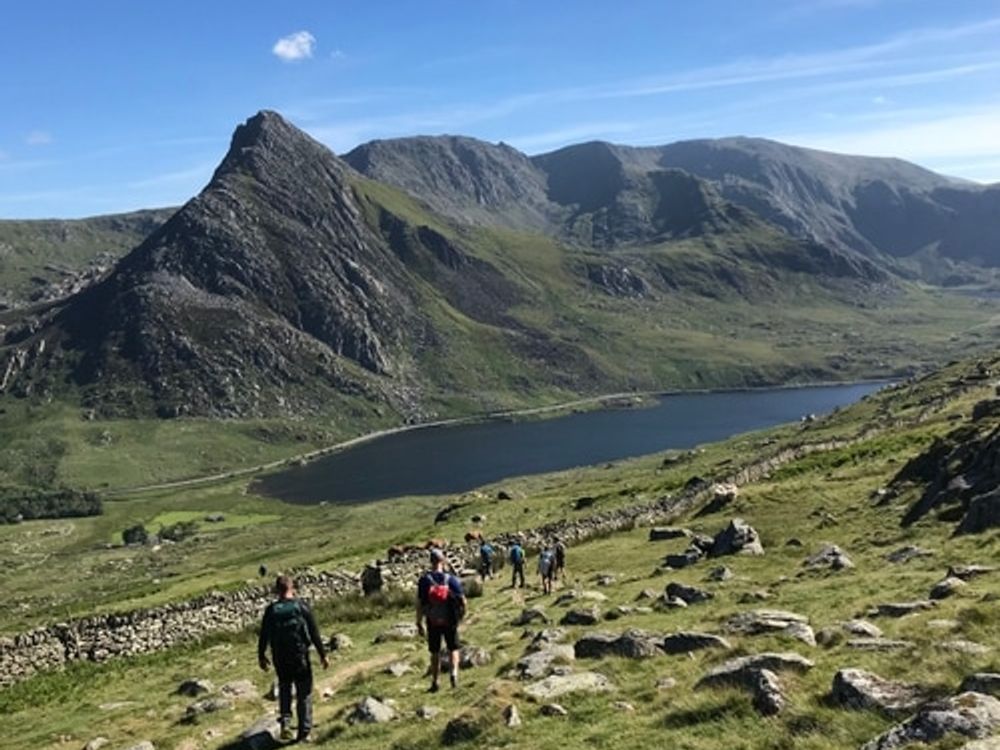 Group hiking towards lake