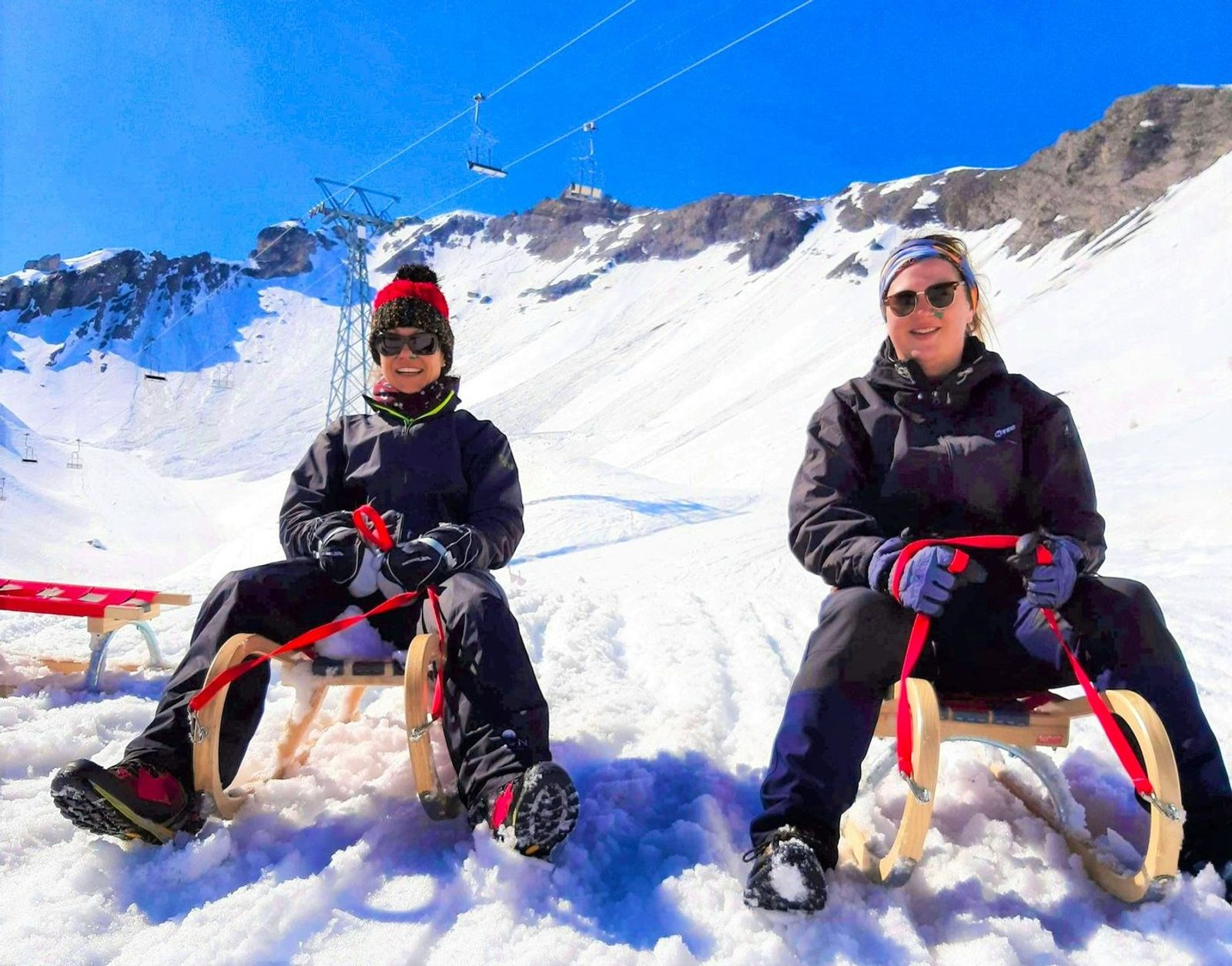 Sledging on wooden sledges in the Swiss Alps