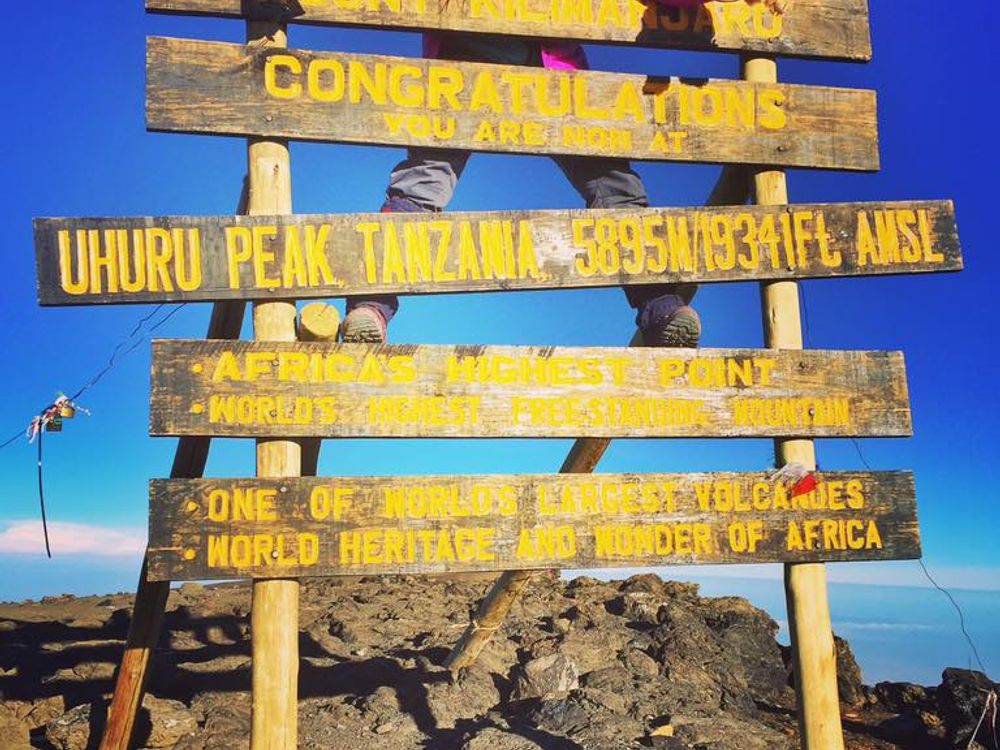 A climber reaching the summit, symbolizing personal achievement