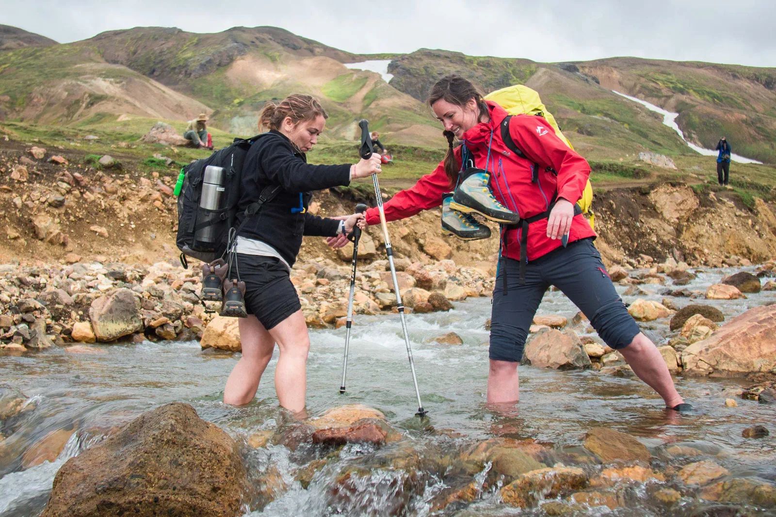 Laugavegur - couple of hikers crossing river