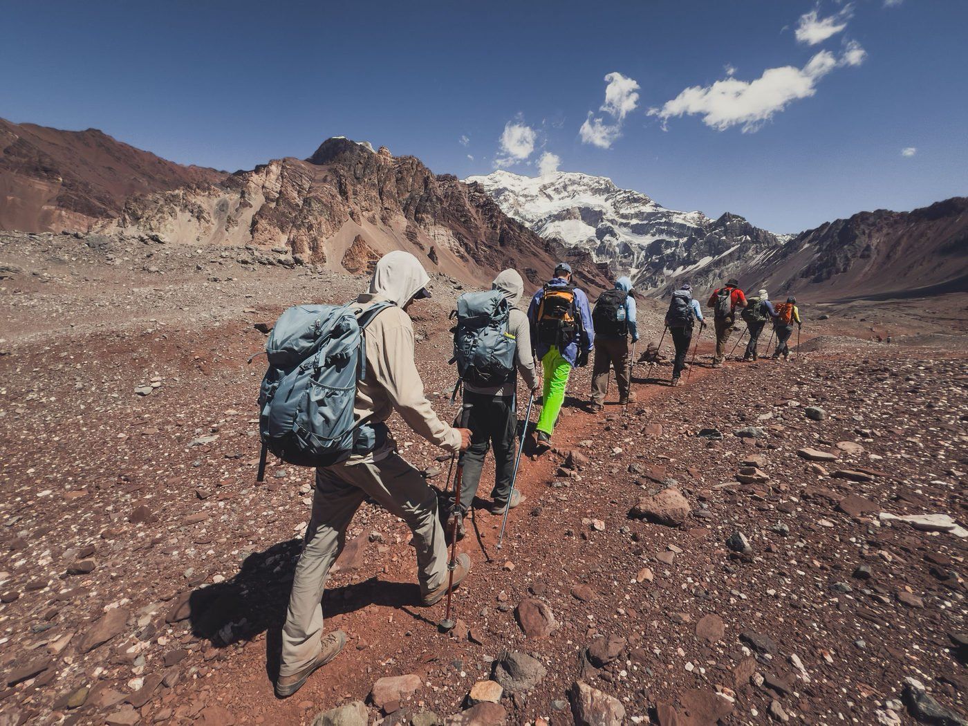 Group trekking across rocky terrain toward Aconcagua