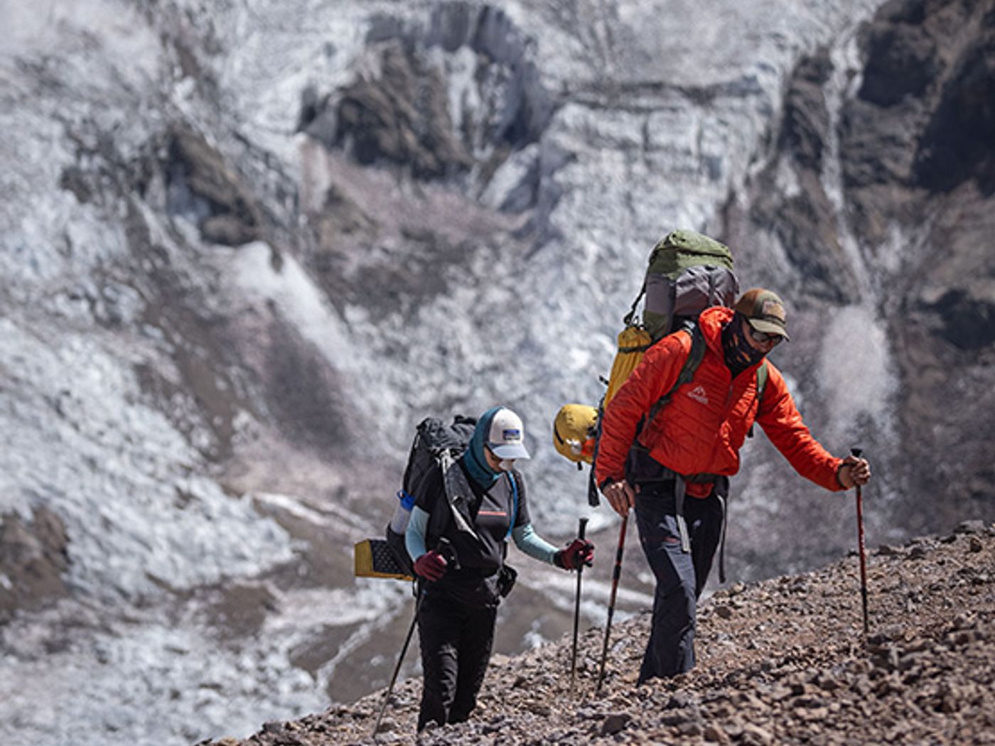 Climbers trekking toward Aconcagua with glacier behind