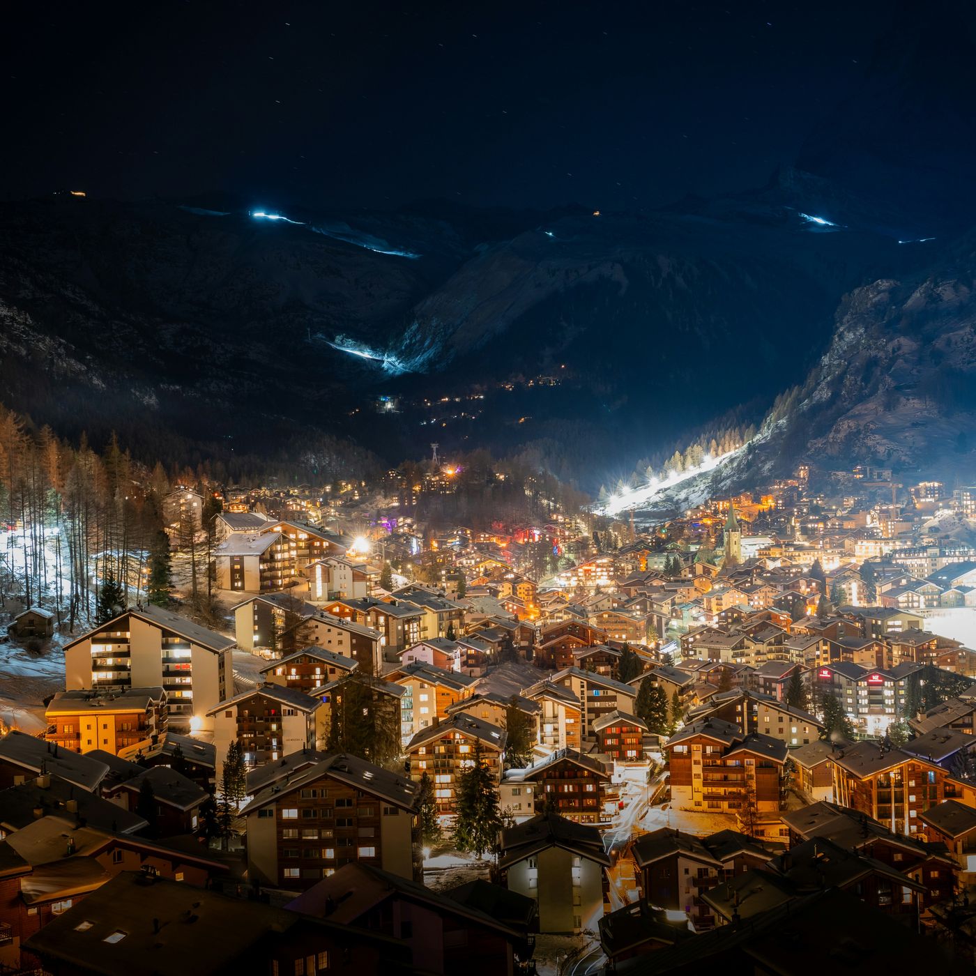 Zermatt village illuminated at night with mountains rising behind