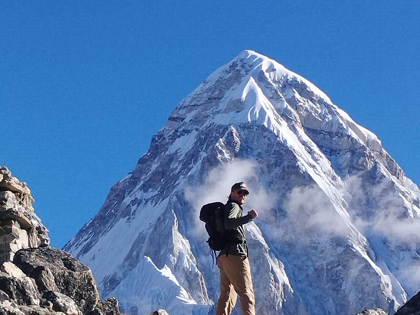 Happy hiker walking to pass