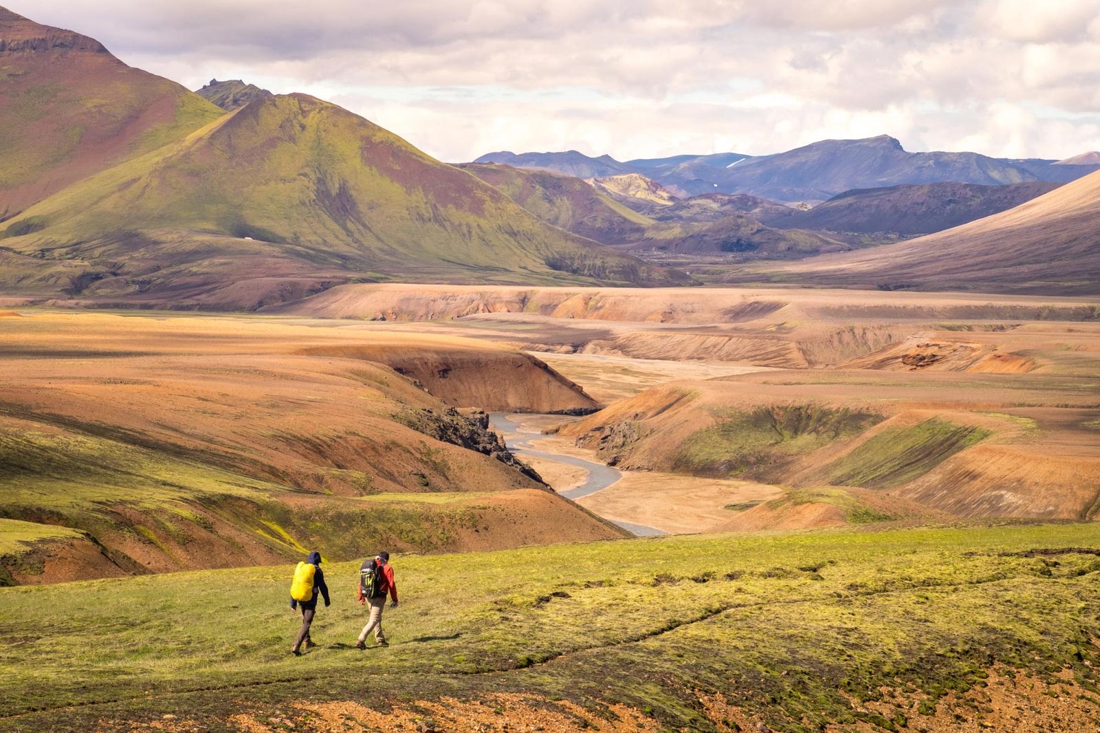 Hikers on nature trail through volcanic landscape