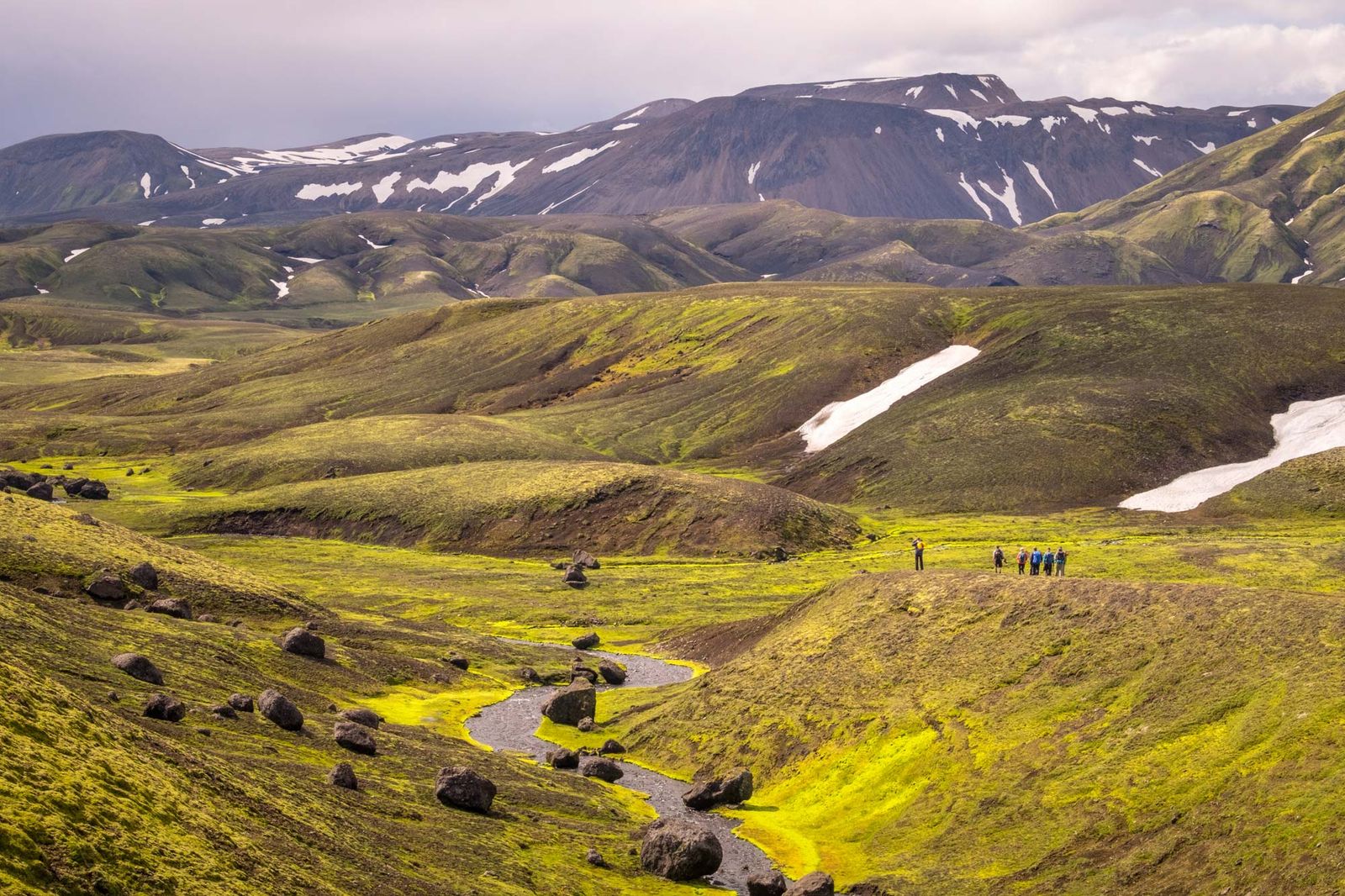 Hikers in Icelandic volcanic landscape