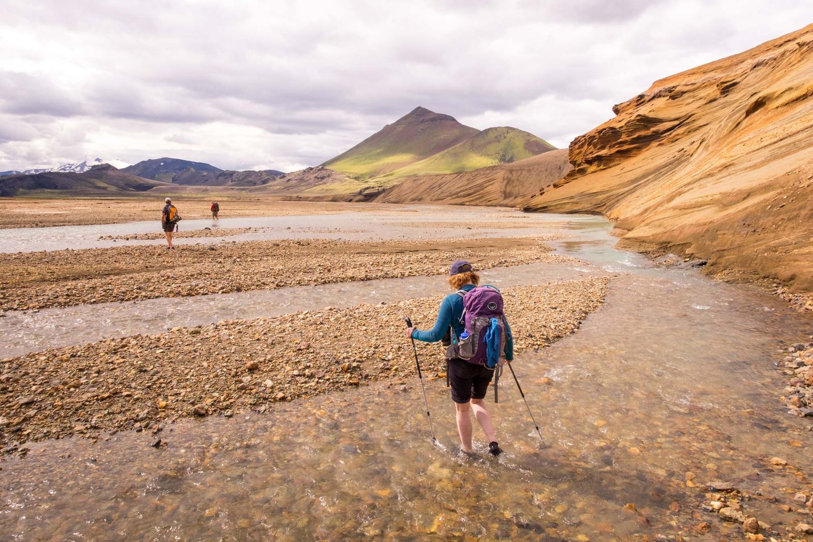 Hiking along river through mountain landscape