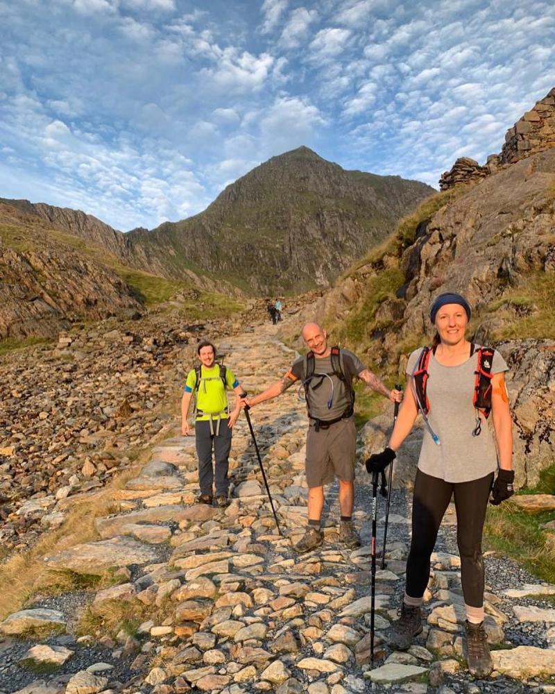 Happy hikers in sunset on National 3 Peaks 