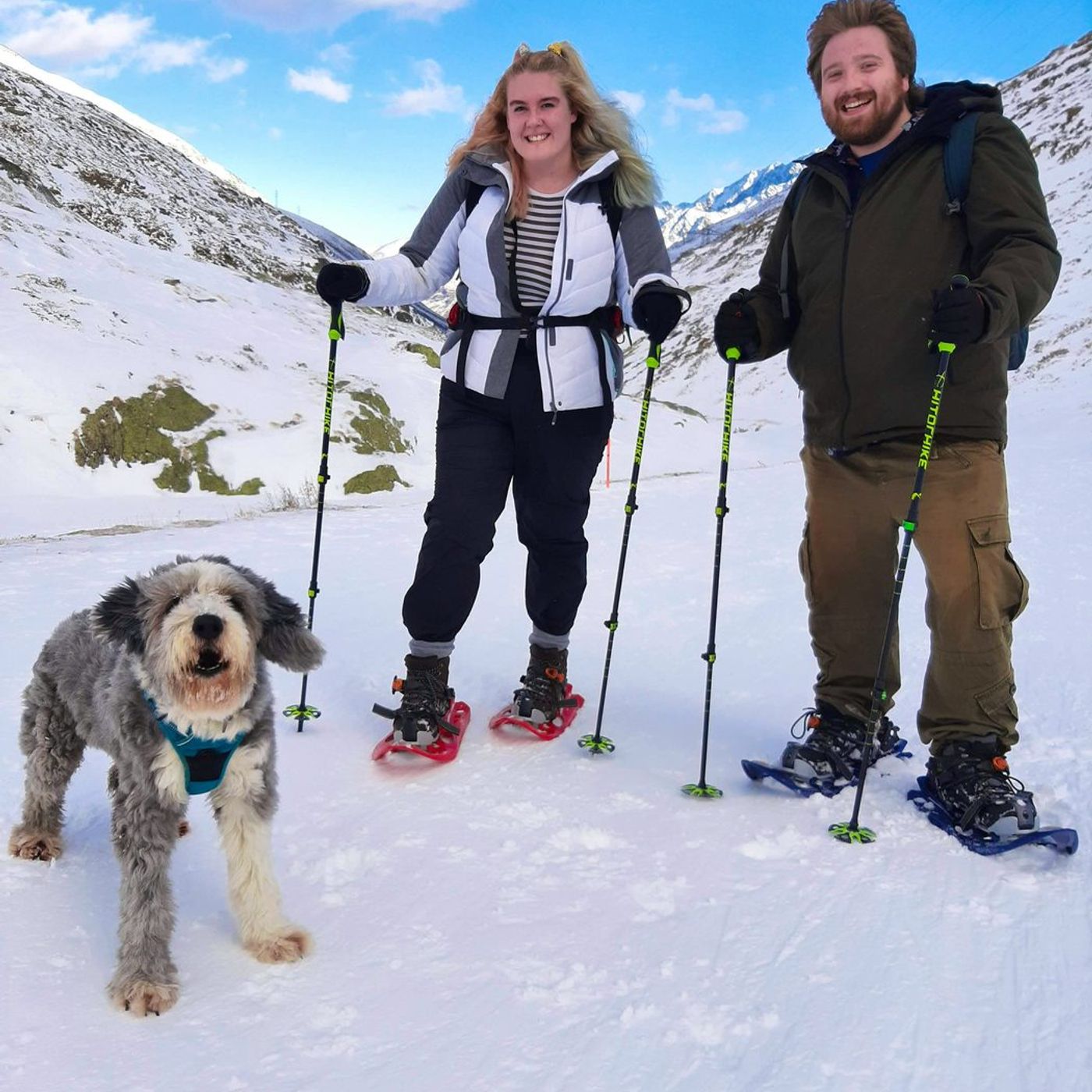 Snowshoeing couple with a dog