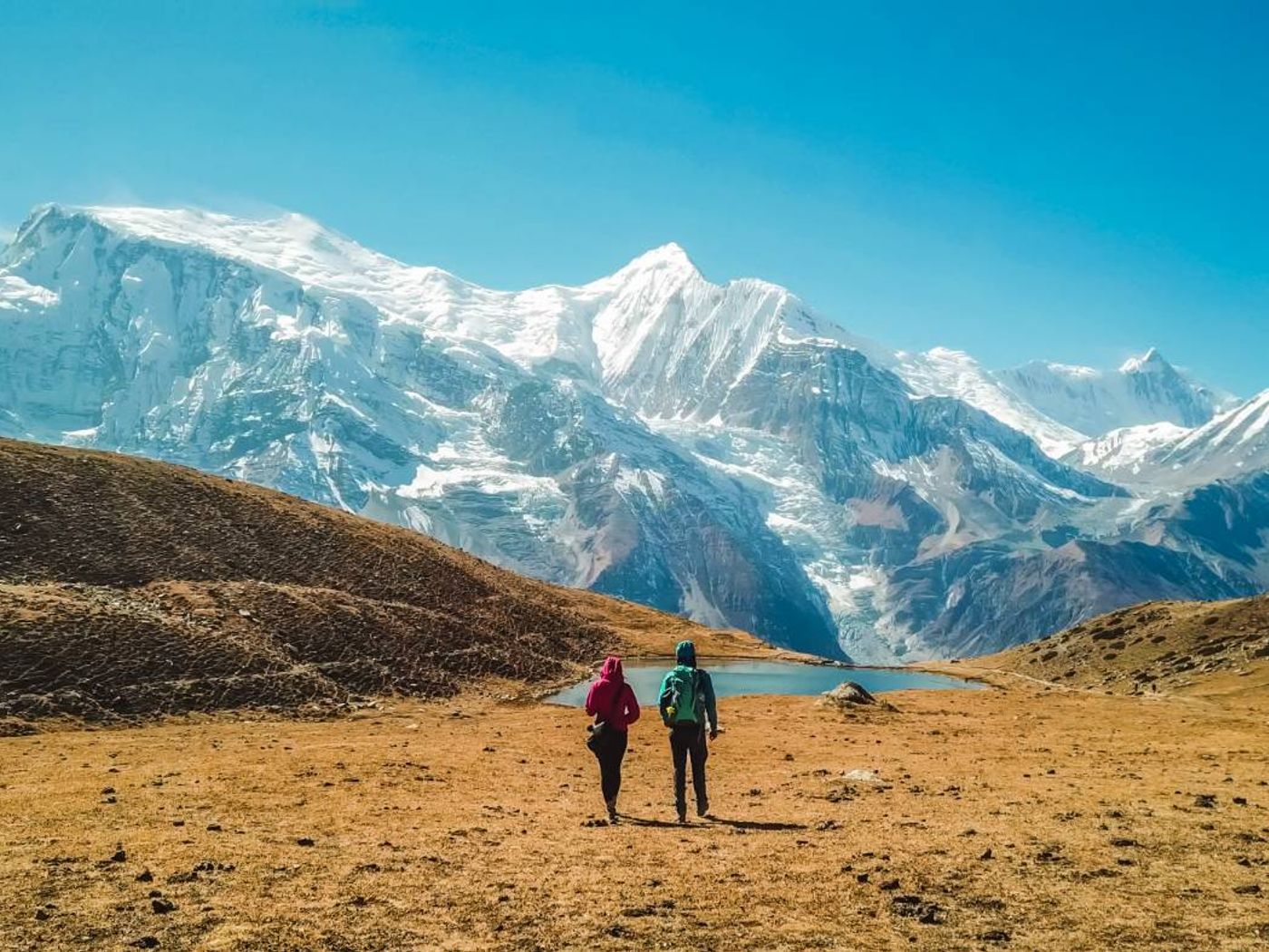 Couple hiking towards lake view