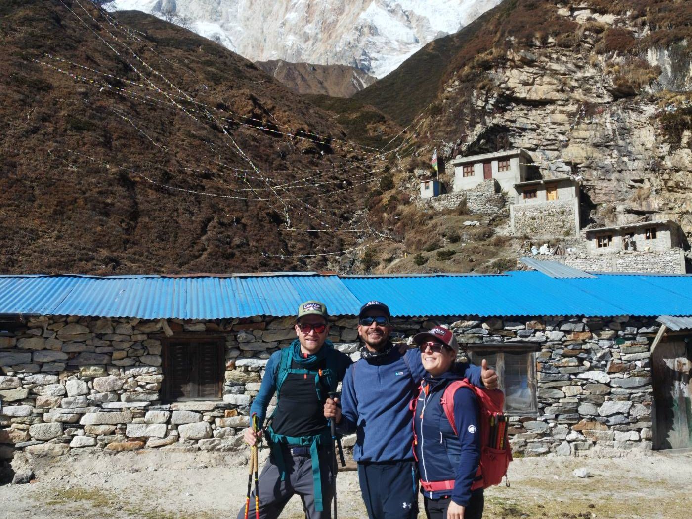 Happy hikers with the north face of Manaslu in the background near Samdo