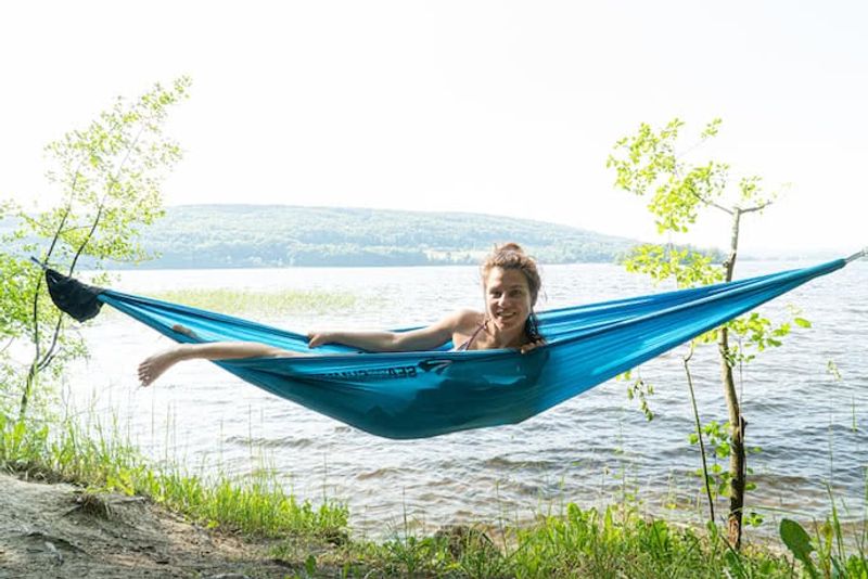 girl in hammock in front of lake