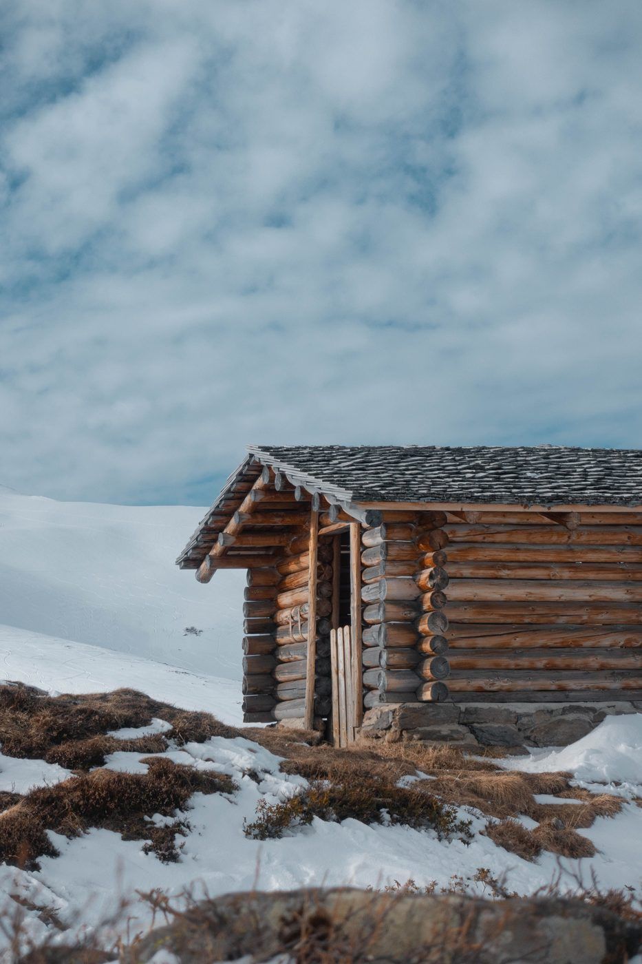 A cosy wooden mountain lodge in the snow