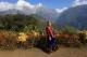 lady in traditional dress stands in front of an Annapurna viewpoint