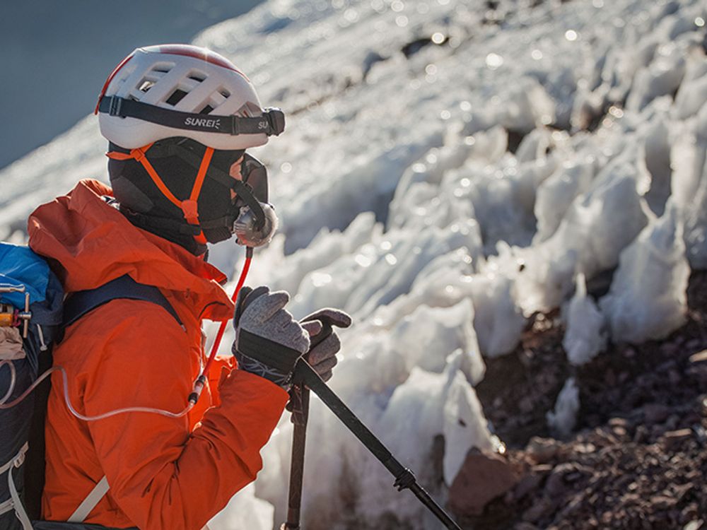 Climber using supplemental oxygen on Aconcagua summit push with ice formations