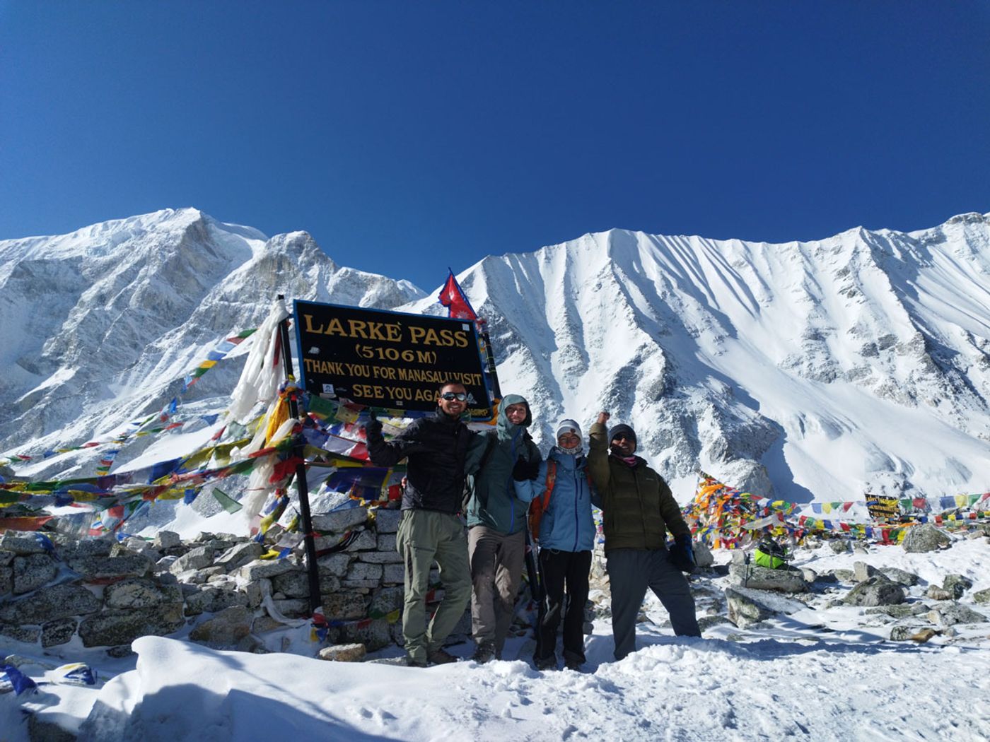 Group celebrating at Larkya La Pass on the Manaslu Circuit