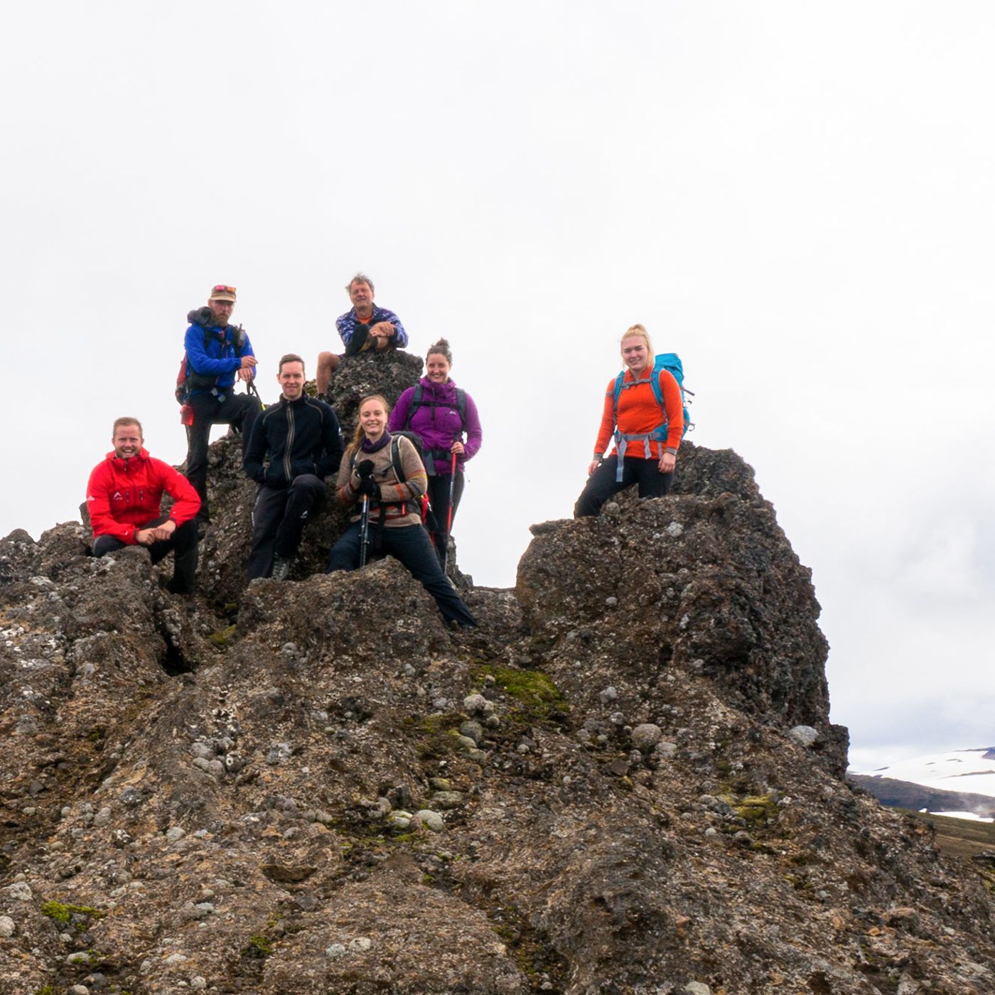 Hiking group at Sveinstindur peak summit with panoramic views