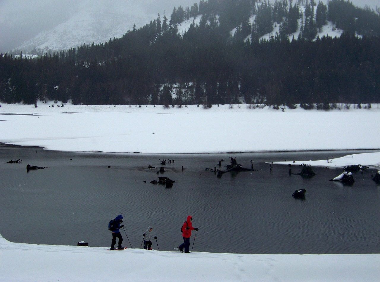 Snowshoeing by a frozen alpine lake