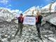 Trekker walking on the Everest Base Camp trail with high Himalayan peaks in the background