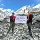 Trekker walking on the Everest Base Camp trail with high Himalayan peaks in the background