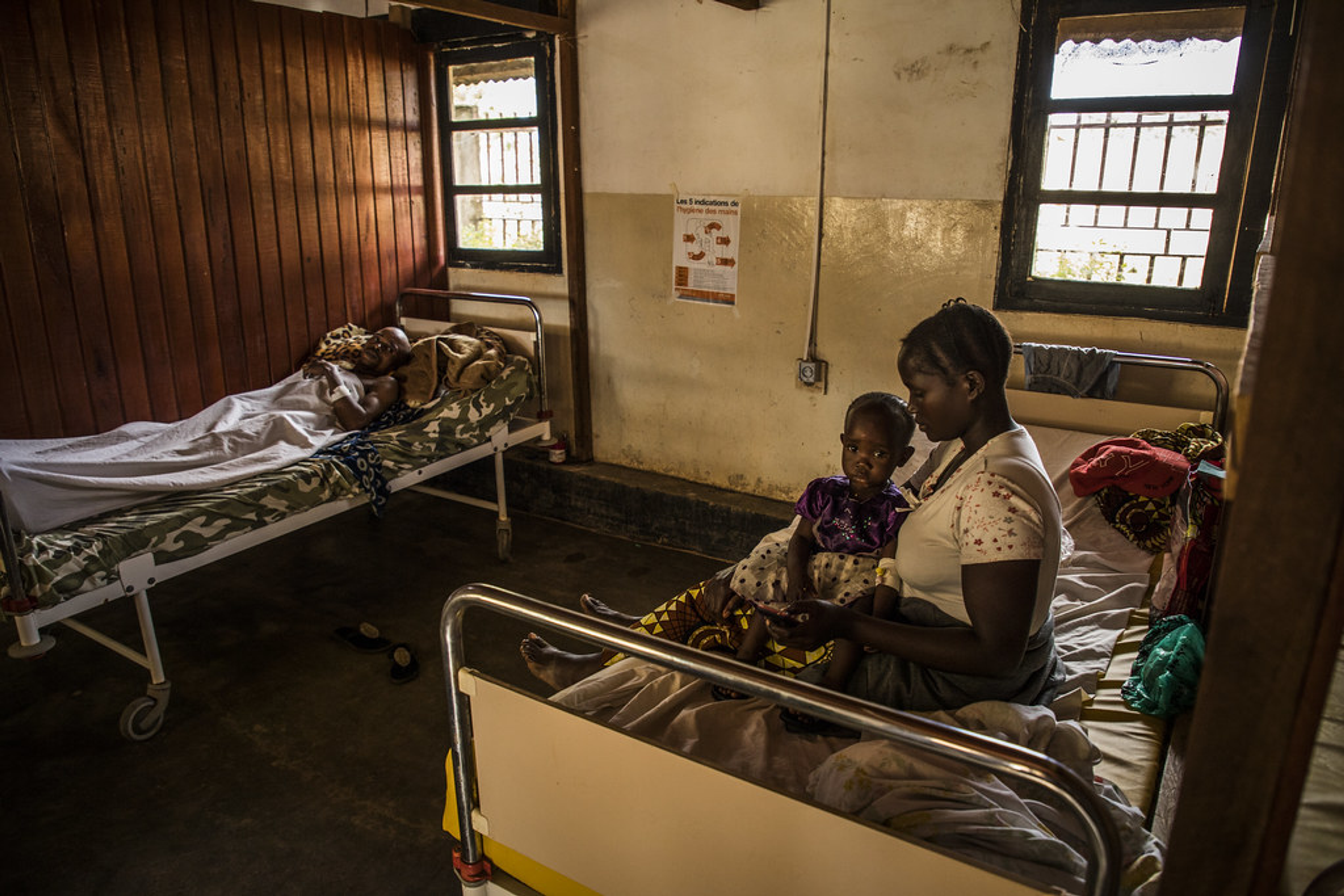 Mother and child in a healthcare center during an Ebola outbreak.