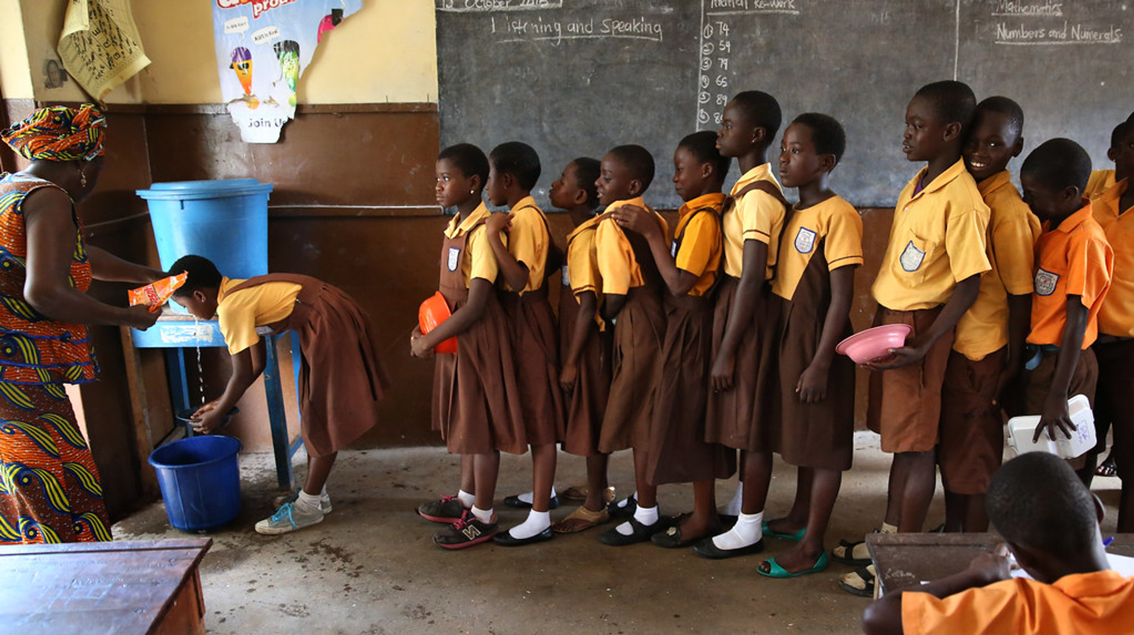 Niños escolares africanos lavándose las manos en la escuela.