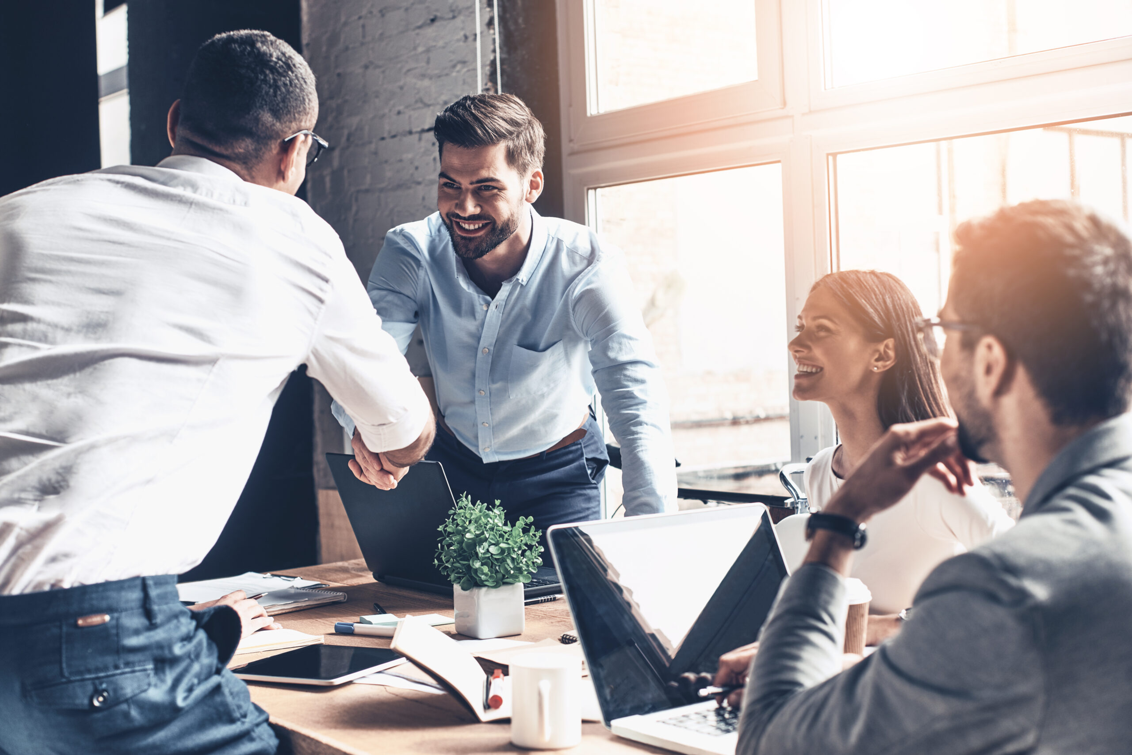 Colleagues shaking hands during a business meeting.