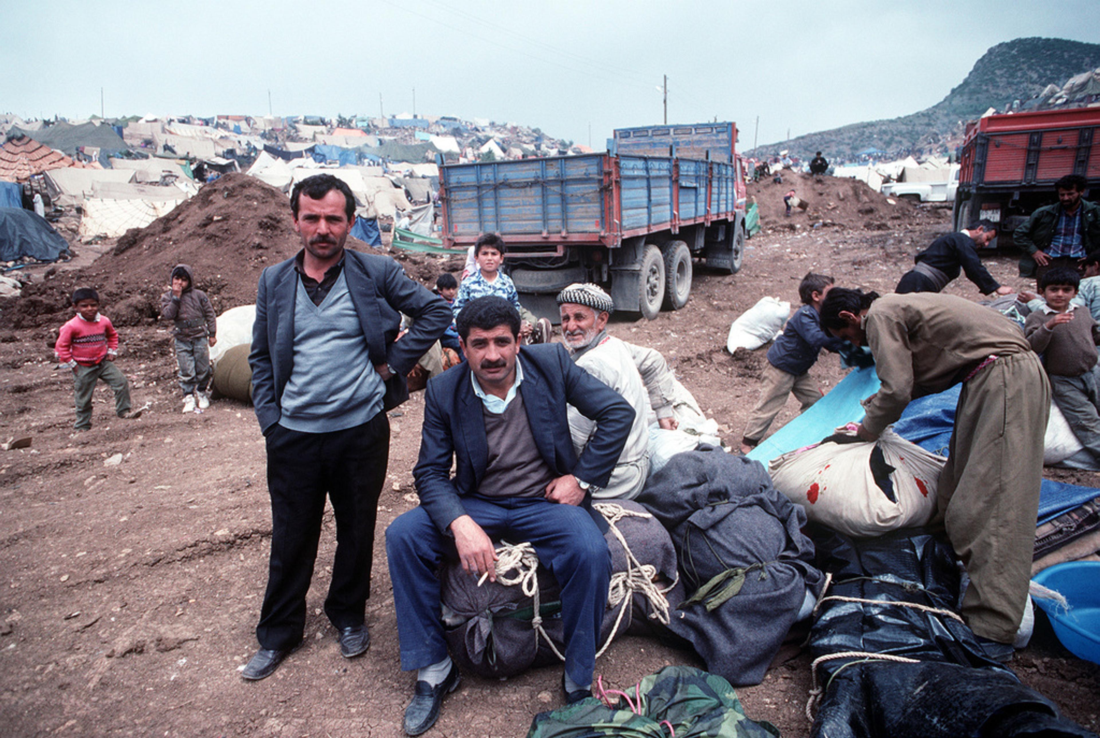 Kurdish families with belongings in a refugee camp near the Turkish-Iraqi border.
