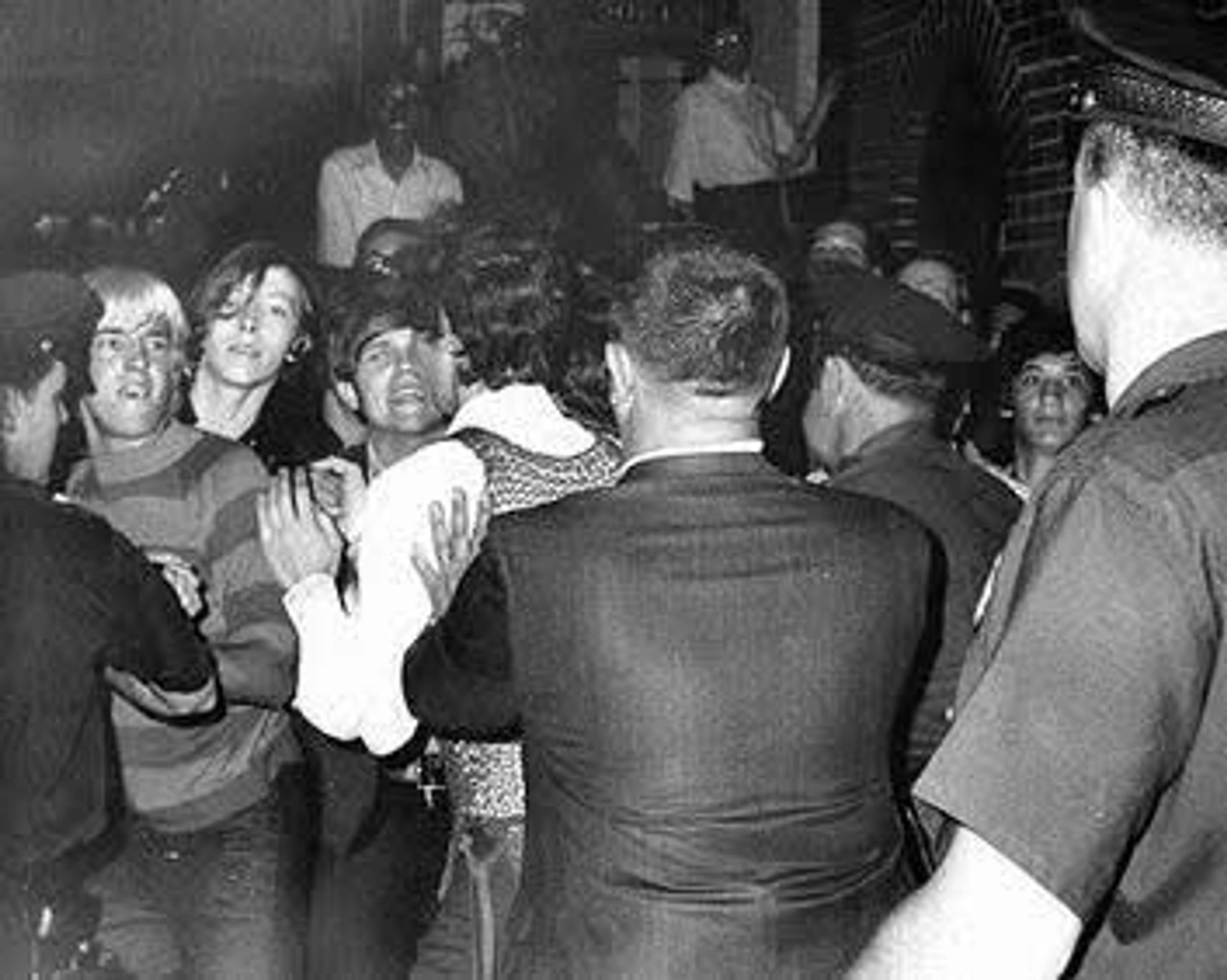 Historic LGBTQ+ activists confronting police during the Stonewall Riots in New York City.