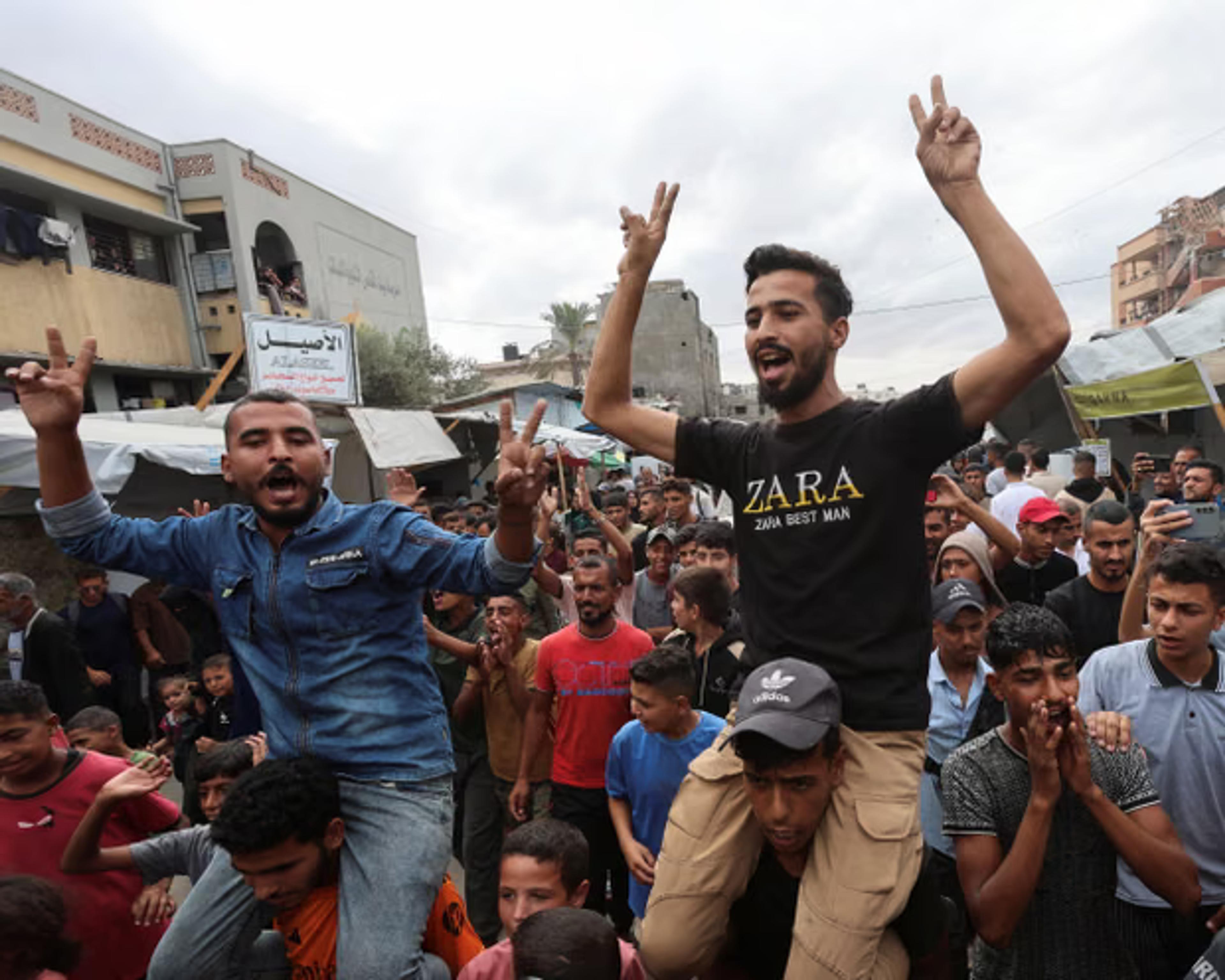 Palestinians celebrate in Khan Younis after the ceasefire was announced