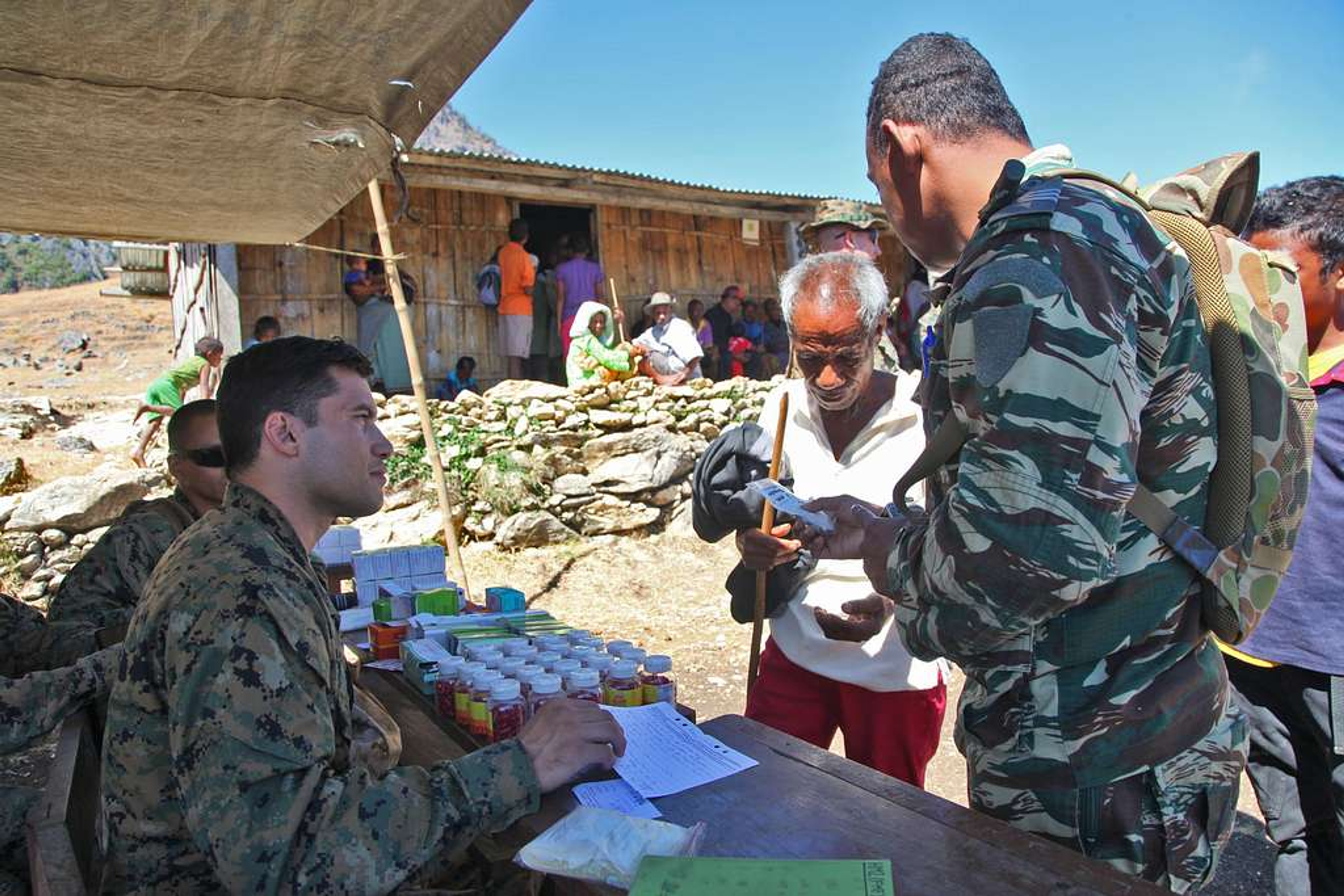 Aid workers distributing medical supplies to civilians during a humanitarian crisis.