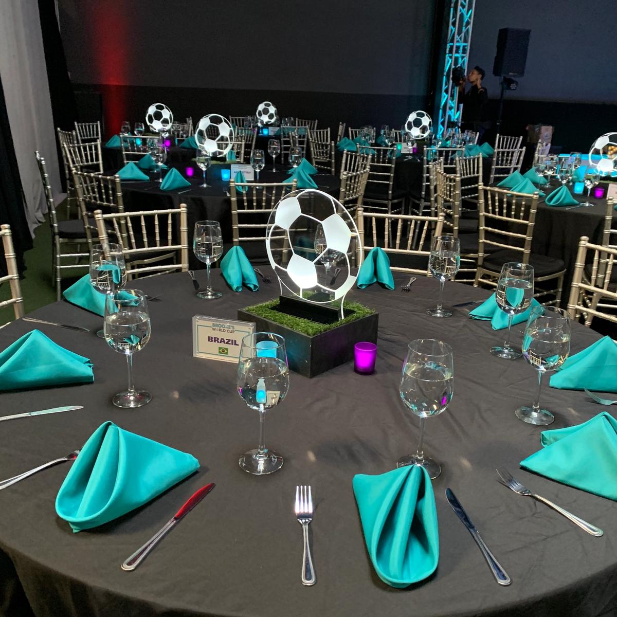 World Cup-themed table settings with soccer ball centerpieces