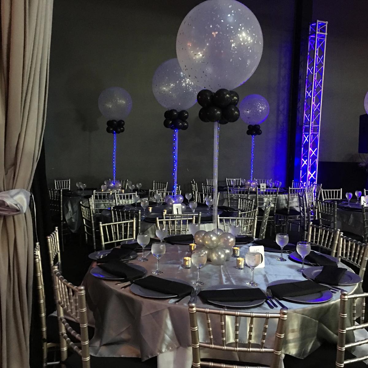 Silver and black table settings with light-up balloon centerpieces