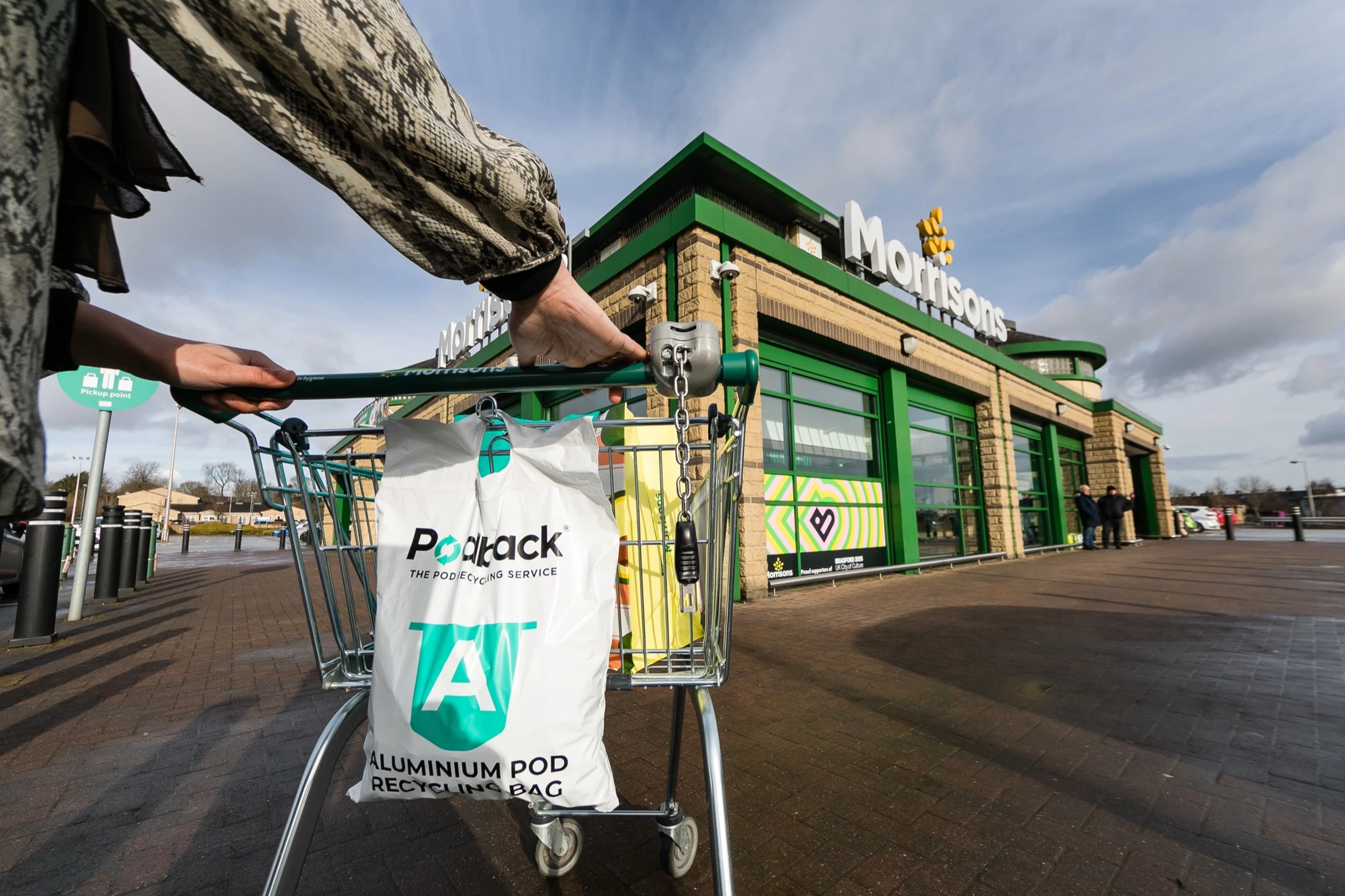 A Podback aluminium pod recycling bag hanging on a trolley outside a Morrisons supermarket