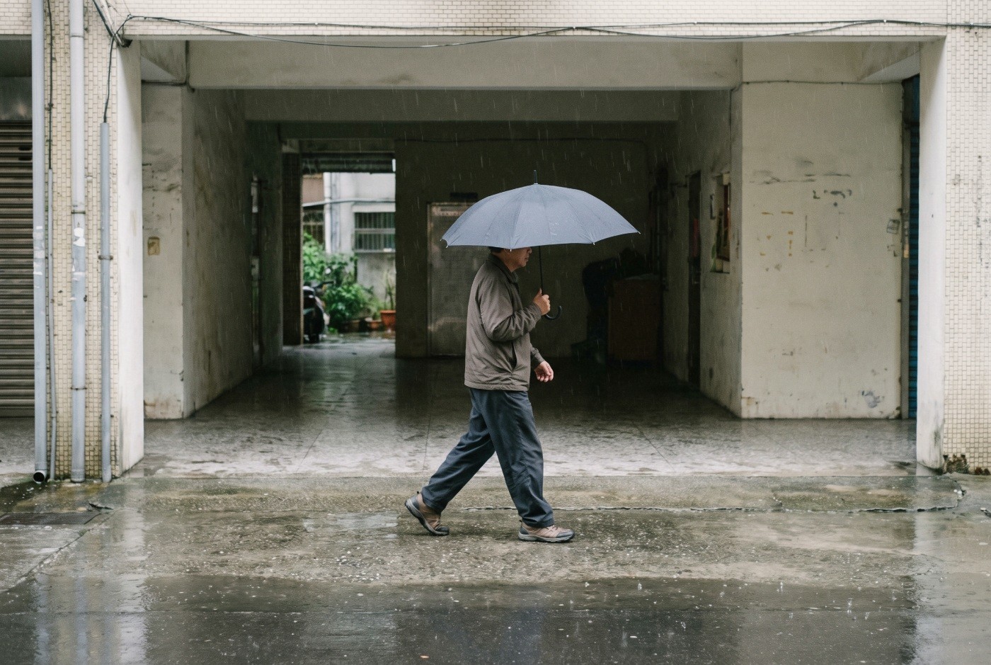 Illustration: Walking with an umbrella past a sheltered arcade.